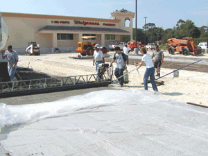 Pervious Concrete lets this new Walgreens Drugstore Parking lot help to heal the thirsty aquifer below.
